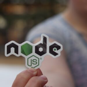 A woman holding a node.js card in her hand.