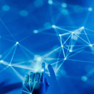 A robotic hand touching a blue accent wall with neural networks on it.