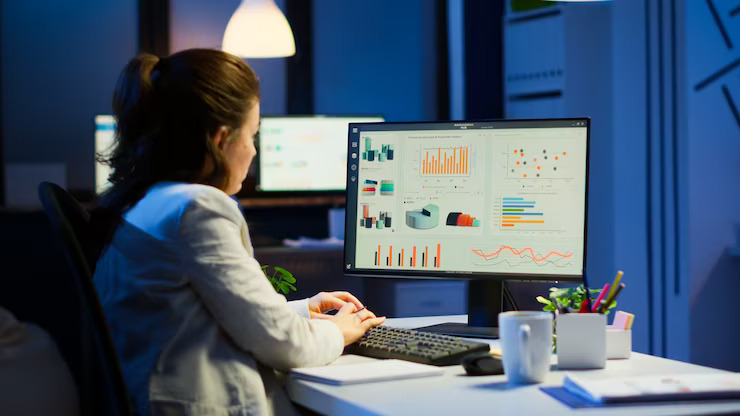 busy-woman-working-night-front-computer-taking-notes-writing-notebook-annual-reports-checking-financial-project-focused-employee-using-technology-network-wireless-doing-overtime-job_482257-13382